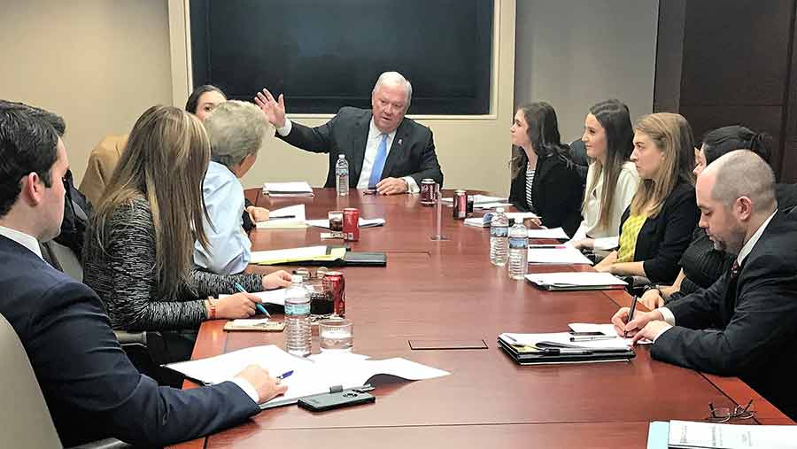 Haley Barbour with faculty member and students